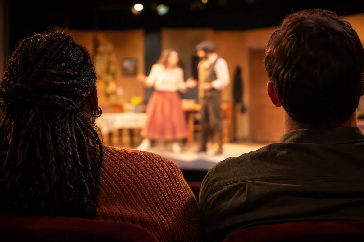 A lively community theatre performance unfolds before a full audience in an intimate Falls Church venue.