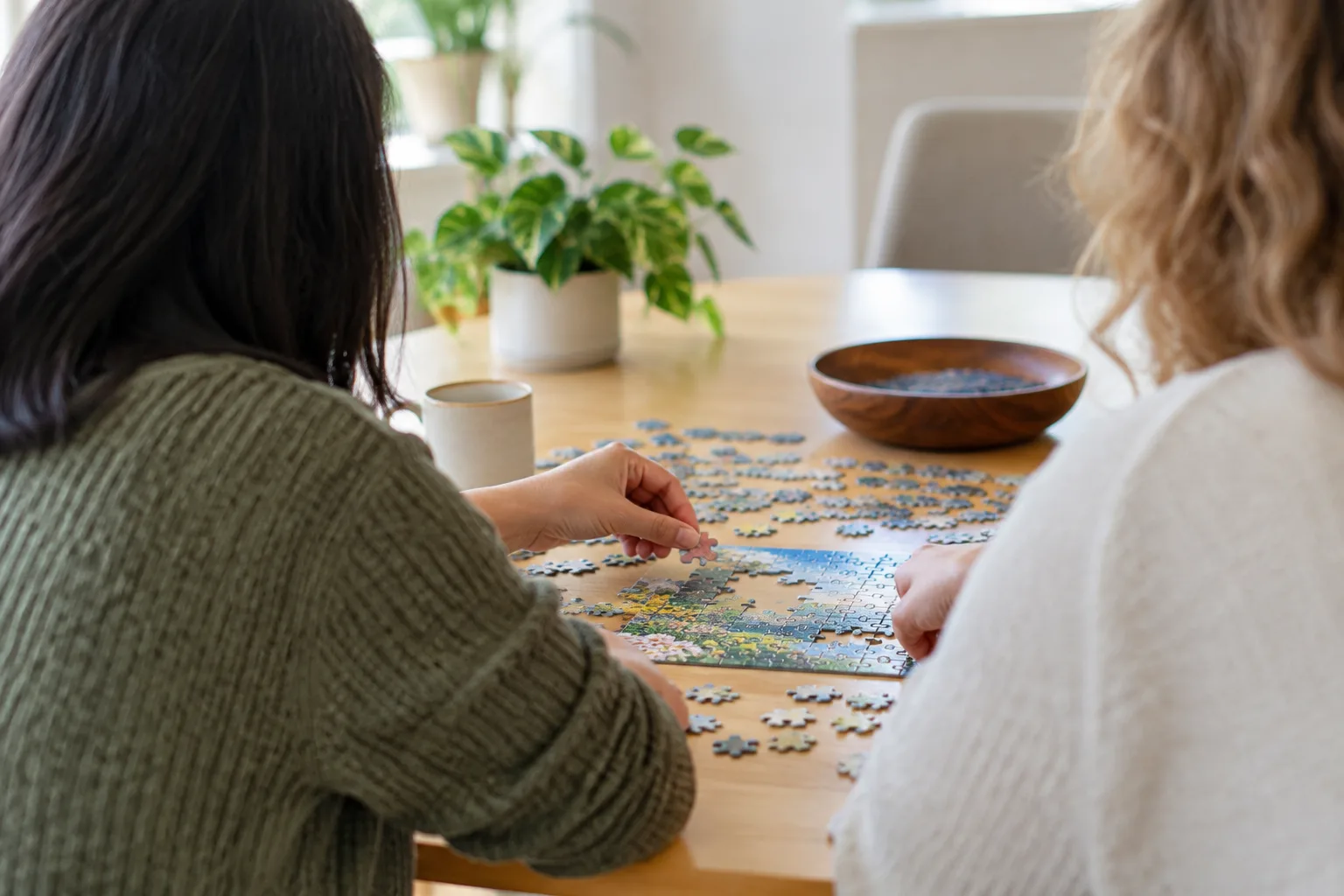 Adults gather around a table for a friendly hobby meetup in a bright Northern Virginia community space.